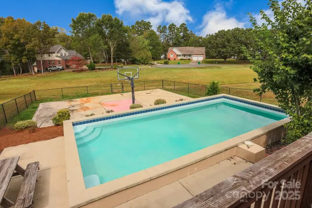 a view of a swimming pool with a yard