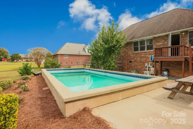 a view of swimming pool with a lounge chairs