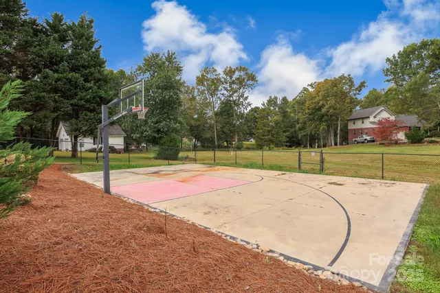 a view of a playground with basketball court