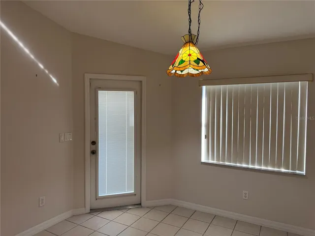 a dining table chair and window in a room