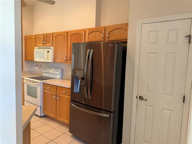 a kitchen with stainless steel appliances a refrigerator and cabinets
