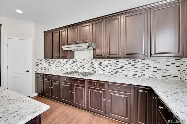 a kitchen with stainless steel appliances granite countertop wooden cabinets and a granite counter tops
