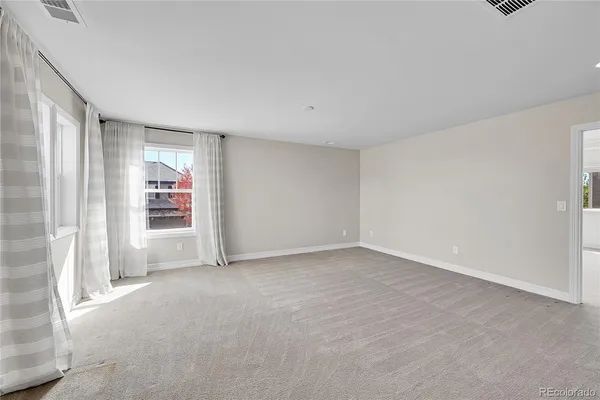 a view of an empty room and a window