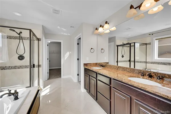 a spacious bathroom with a granite countertop sink a large mirror and a shower