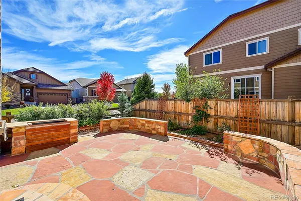 a view of a house with backyard and sitting area