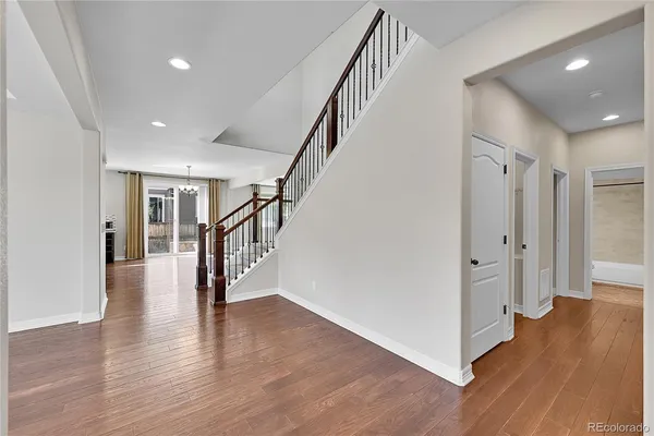 a view of entryway with wooden floors and stairs