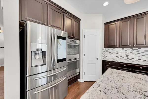 a kitchen with stainless steel appliances a refrigerator and a stove top oven