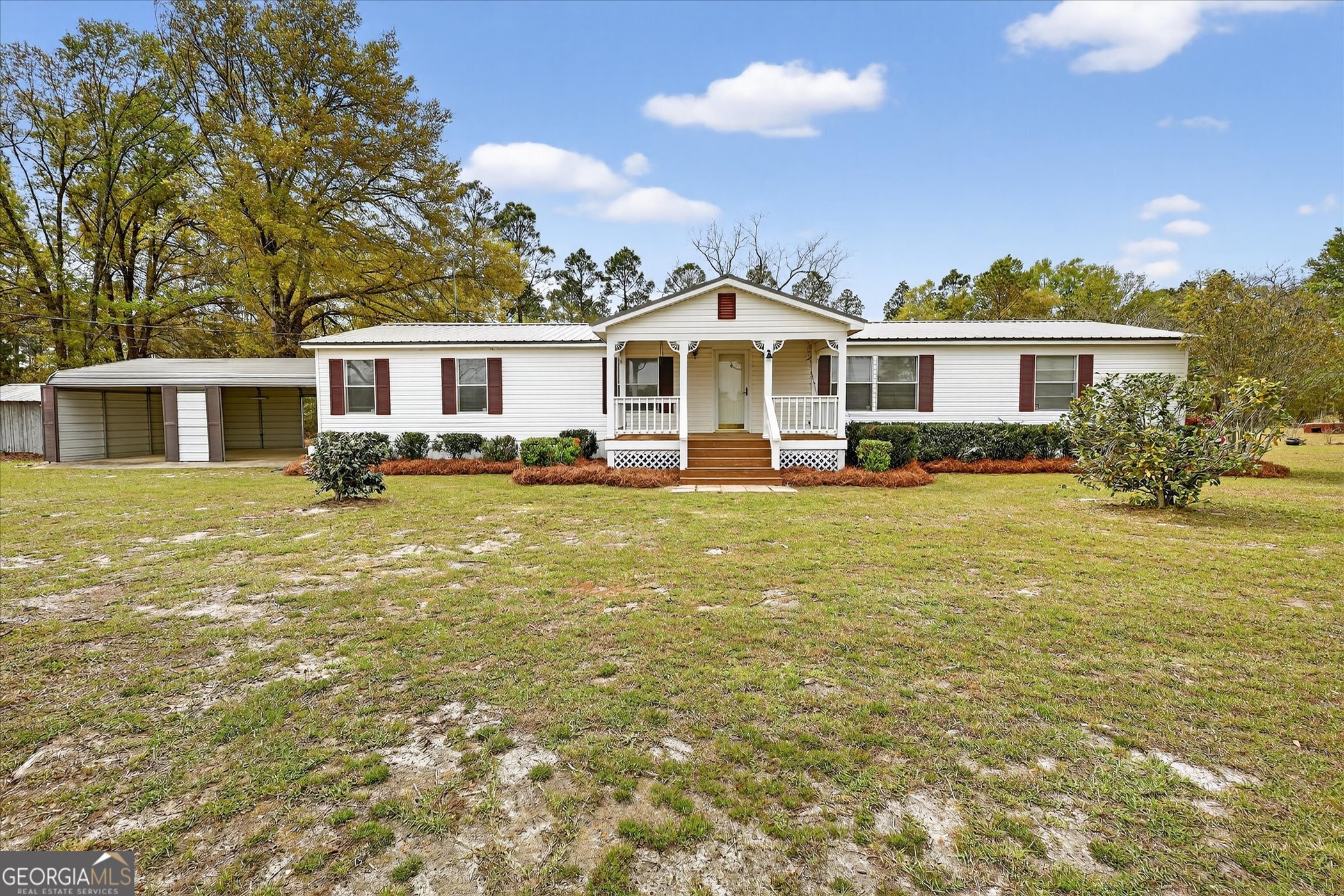 13541 Pine Burr Road Metter, GA 30439 - Photo 1 of 44 a front view of a house with a garden and trees