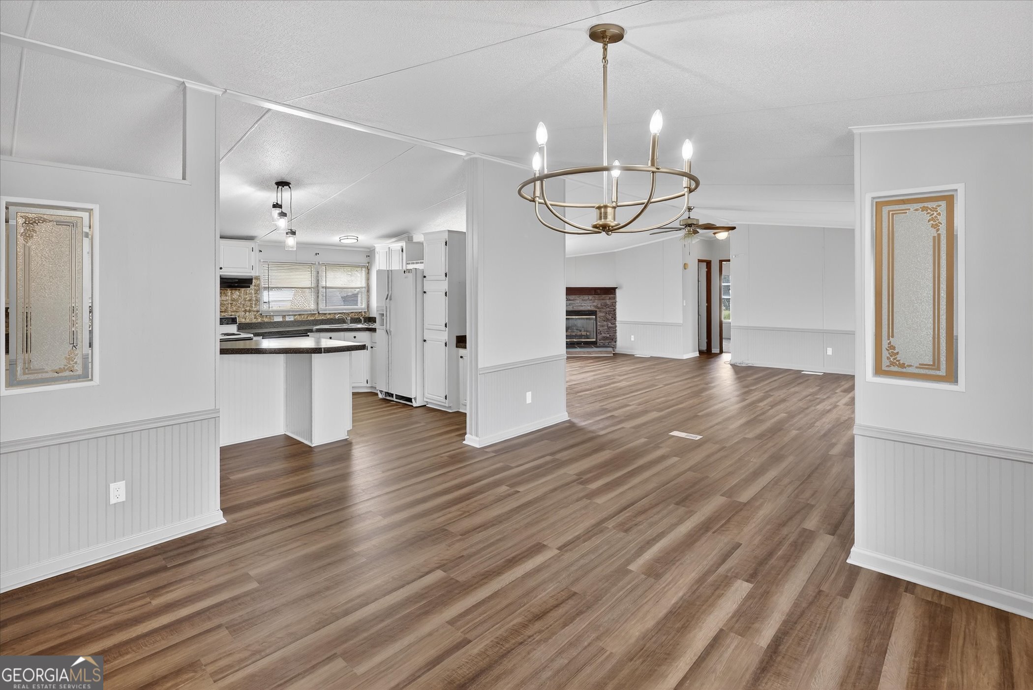 13541 Pine Burr Road Metter, GA 30439 - Photo 11 of 44 a view of a kitchen with wooden floor and stainless steel appliances