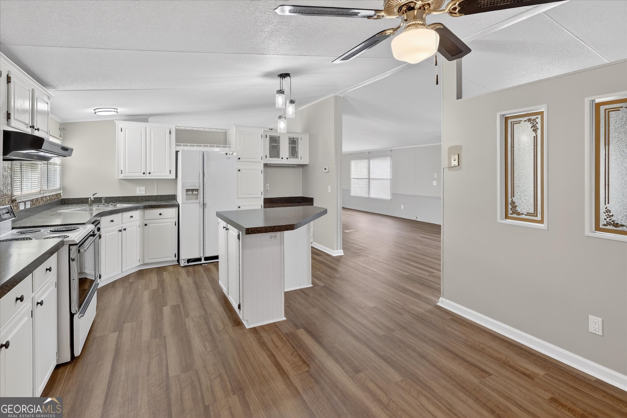 13541 Pine Burr Road Metter, GA 30439 - Photo 13 of 44 a kitchen with a sink a counter space appliances and cabinets