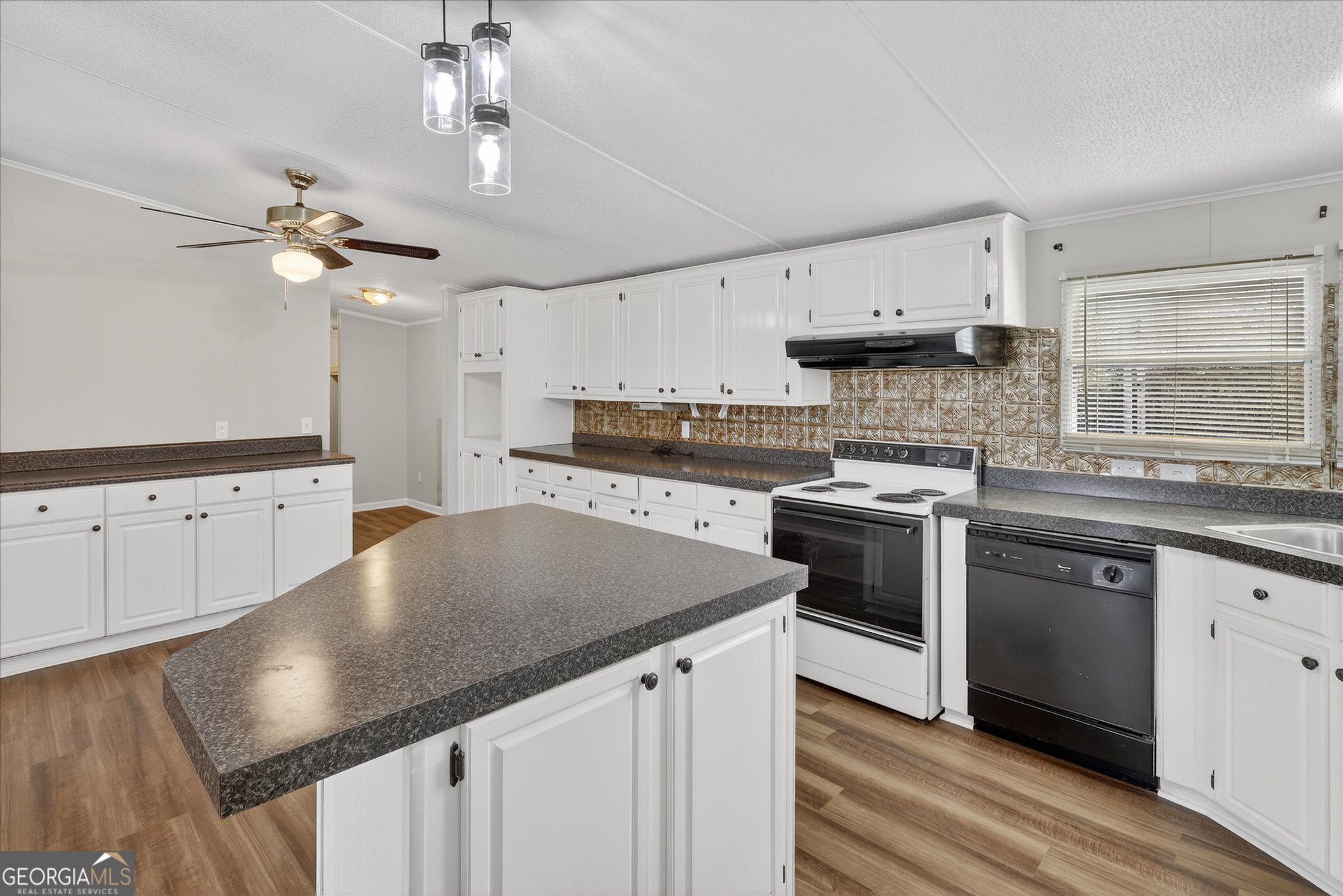 13541 Pine Burr Road Metter, GA 30439 - Photo 15 of 44 a kitchen with stainless steel appliances granite countertop a stove a sink dishwasher and a refrigerator