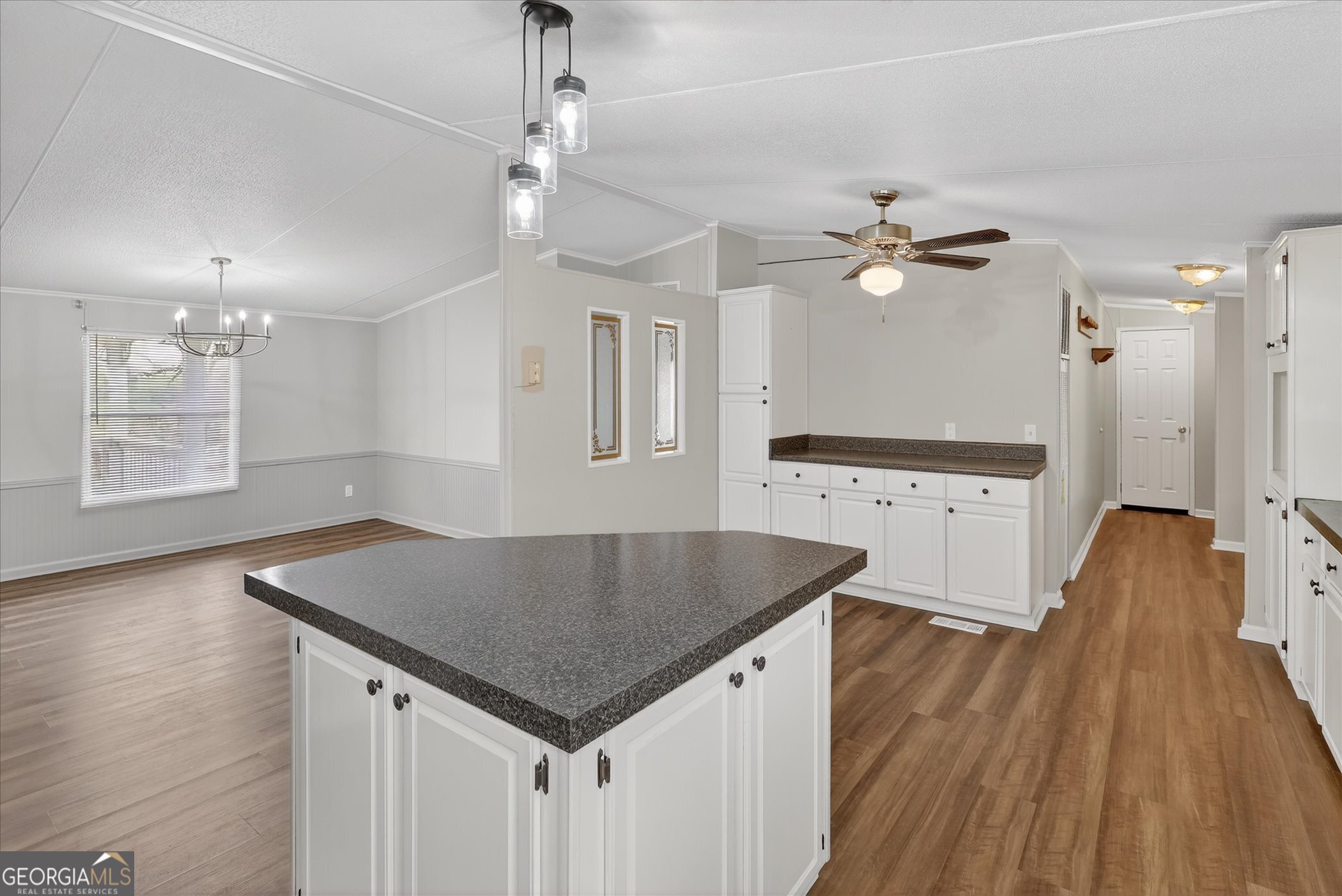 13541 Pine Burr Road Metter, GA 30439 - Photo 16 of 44 an open kitchen with a table and chandelier