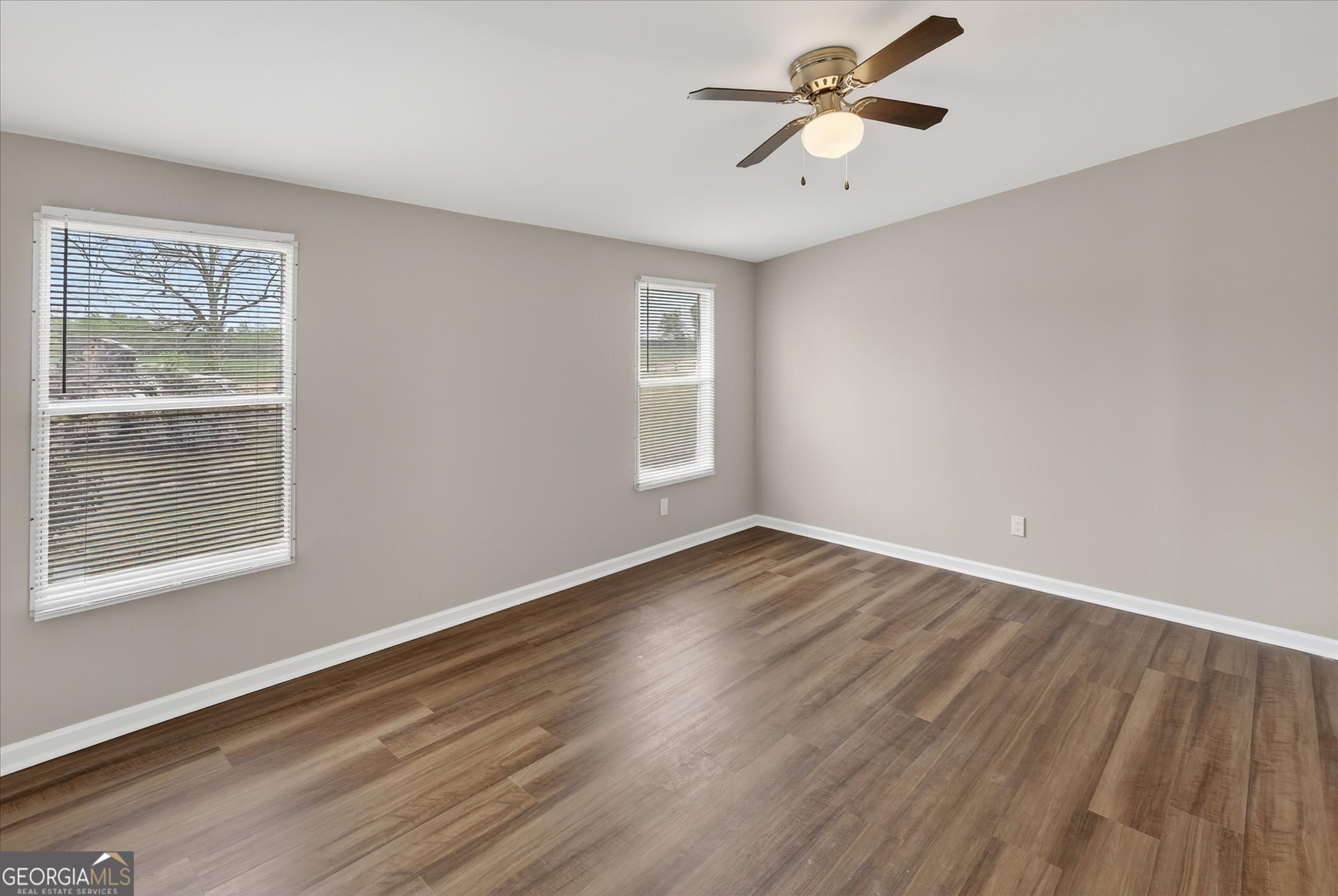 13541 Pine Burr Road Metter, GA 30439 - Photo 18 of 44 a view of empty room with wooden floor and fan