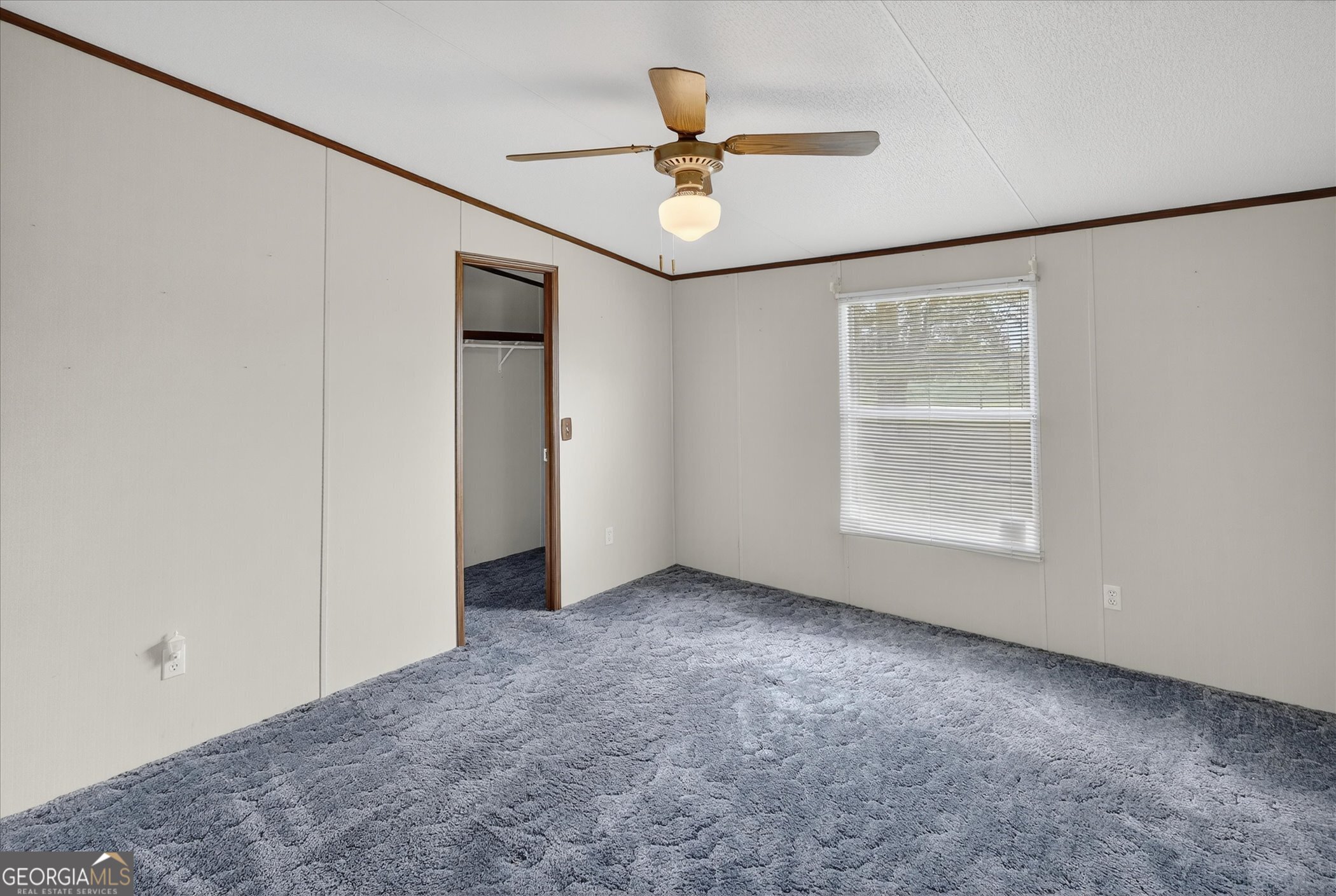 13541 Pine Burr Road Metter, GA 30439 - Photo 23 of 44 an empty room with windows and ceiling fan