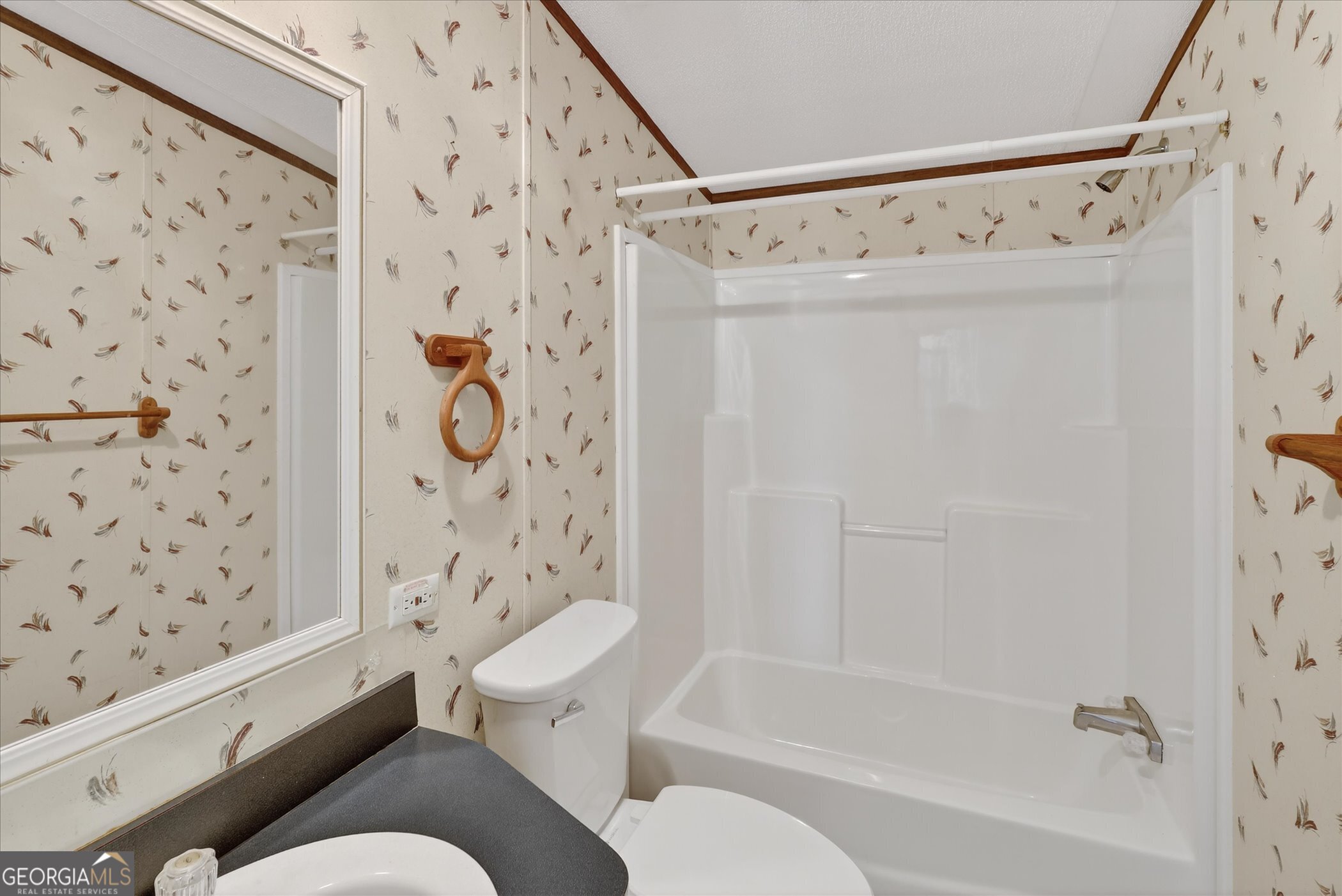 13541 Pine Burr Road Metter, GA 30439 - Photo 25 of 44 a bathroom with a toilet and a shower curtain