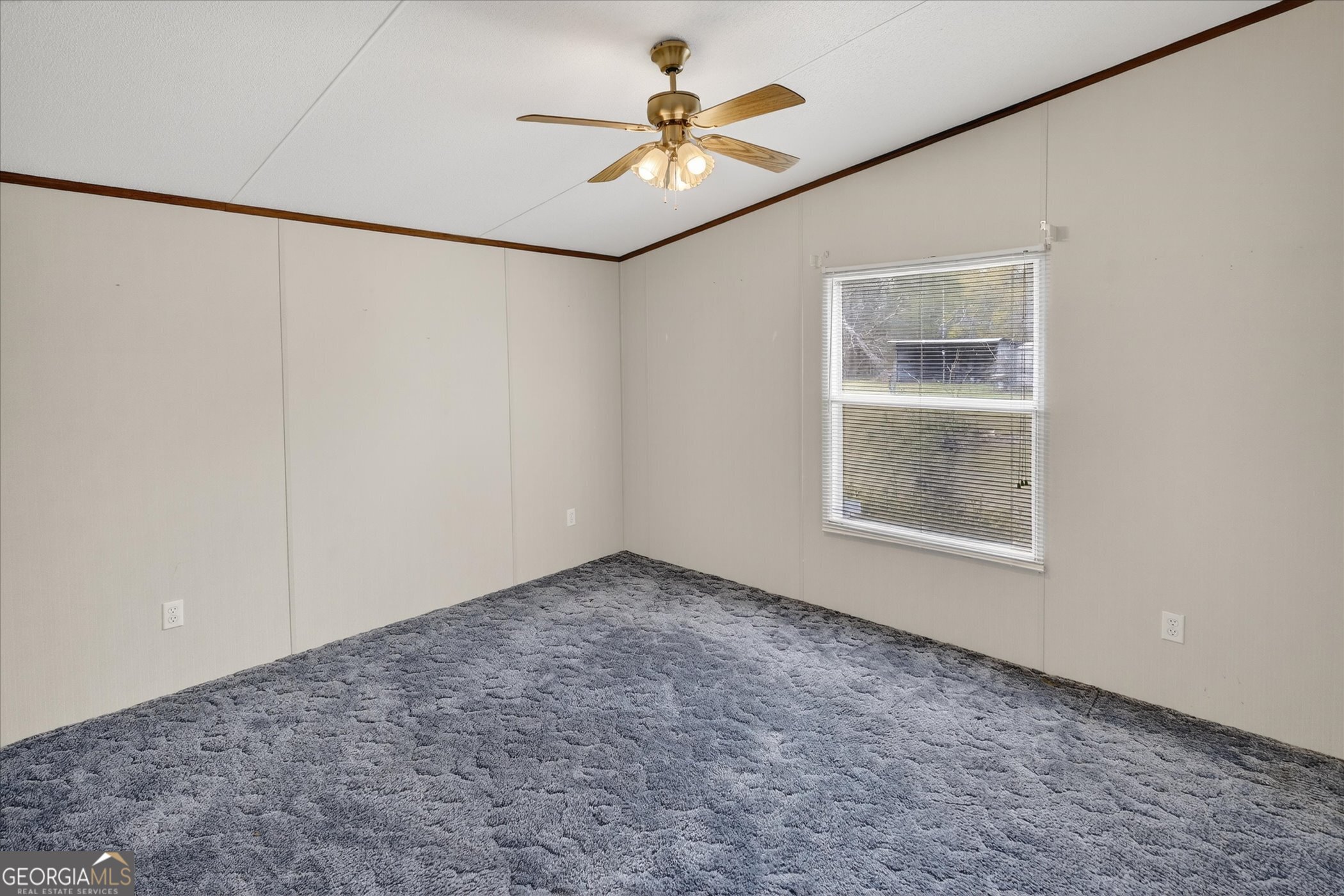 13541 Pine Burr Road Metter, GA 30439 - Photo 27 of 44 an empty room with windows and fan