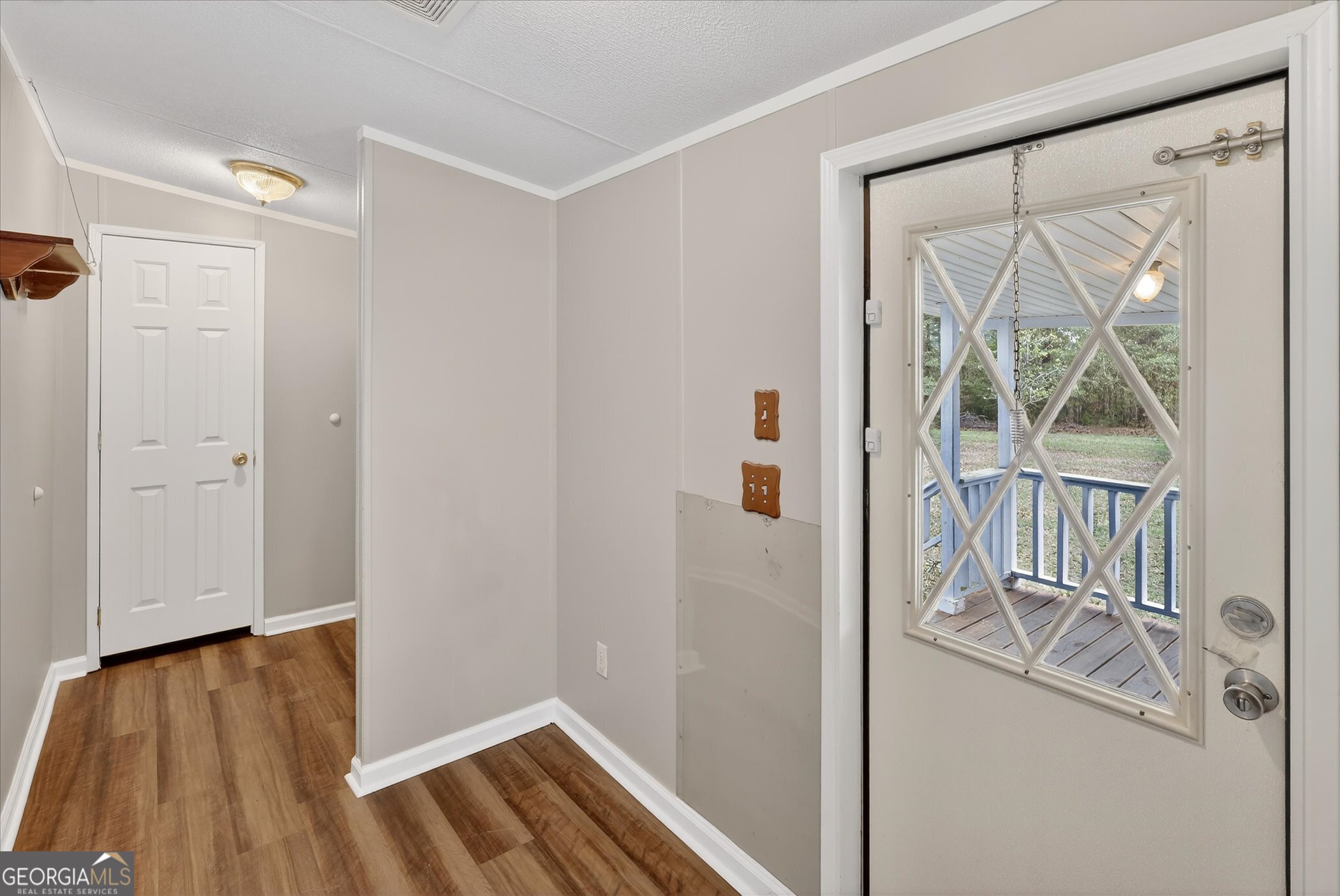 13541 Pine Burr Road Metter, GA 30439 - Photo 29 of 44 a view of front door with wooden floor and a gate