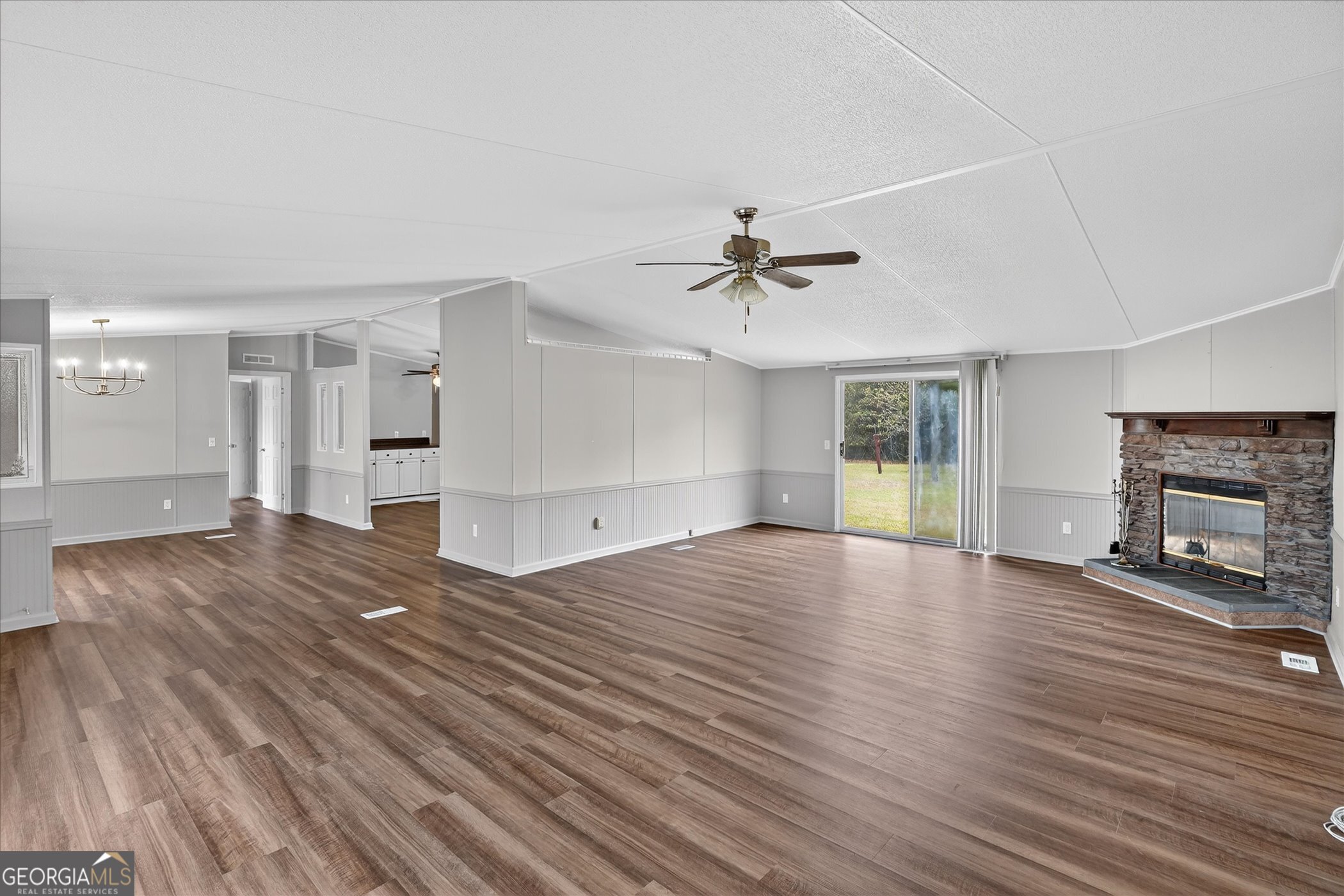 13541 Pine Burr Road Metter, GA 30439 - Photo 6 of 44 a view of empty room with wooden floor and fireplace