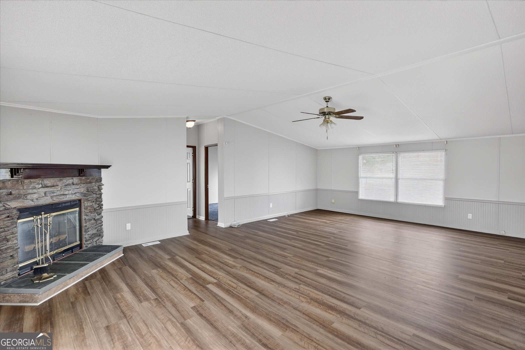 13541 Pine Burr Road Metter, GA 30439 - Photo 7 of 44 a view of empty room with wooden floor and fireplace