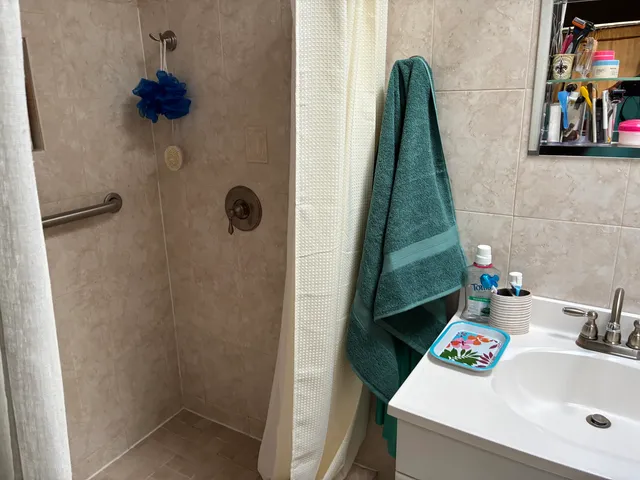 a bathroom with a sink toilet and a shower