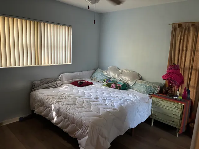a bedroom with a bed and a window
