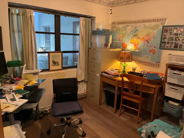 a work room with furniture and a bookshelf