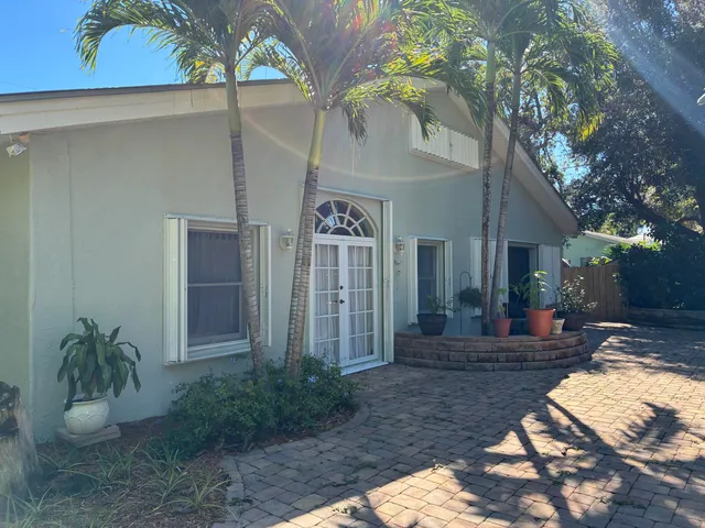 a view of a house with a patio and a yard