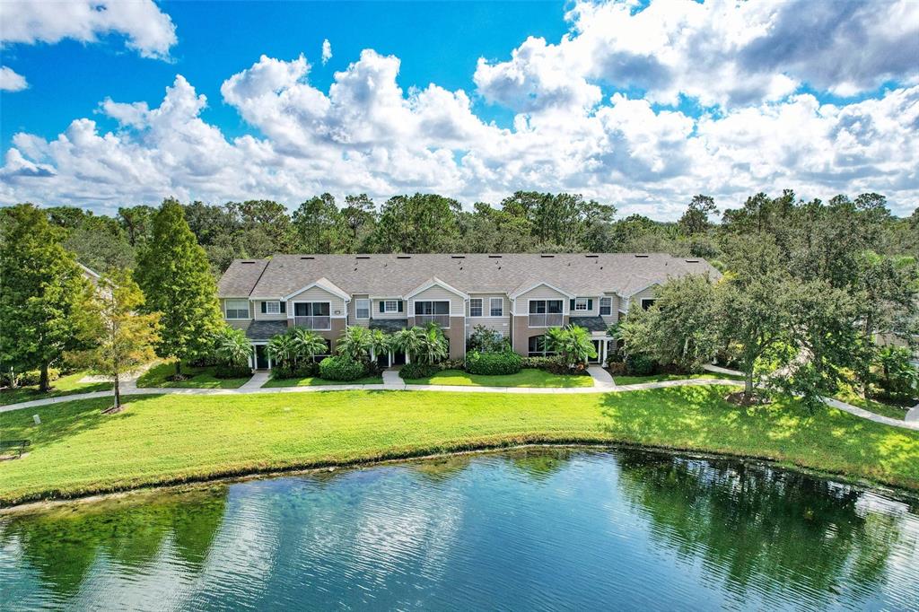 8809 Manor Loop, Unit 206 Lakewood Ranch, FL 34202 - Photo 1 of 1 a view of a house with a yard and a swimming pool