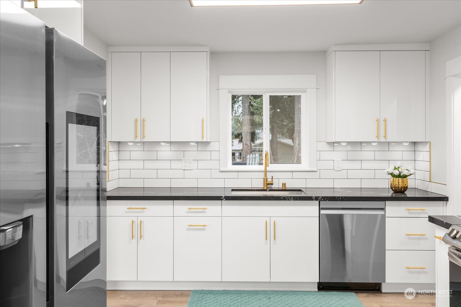 6919 Cady Road Everett, WA 98203 - Photo 12 of 39 a kitchen with white cabinets sink and appliances