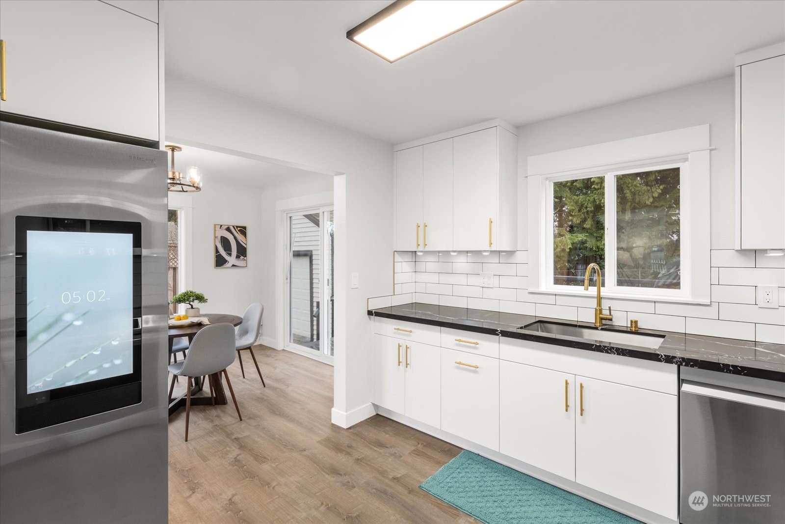6919 Cady Road Everett, WA 98203 - Photo 15 of 39 a kitchen with granite countertop sink table and chairs