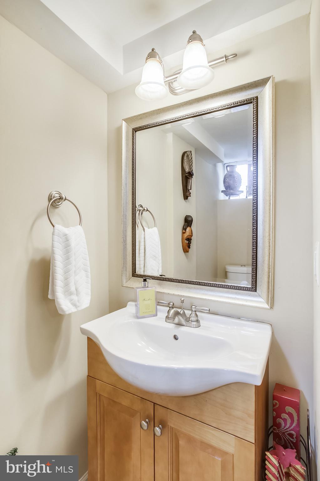 1409 Langford Road Baltimore, MD 21207 - Photo 32 of 39 a bathroom with a sink and mirror