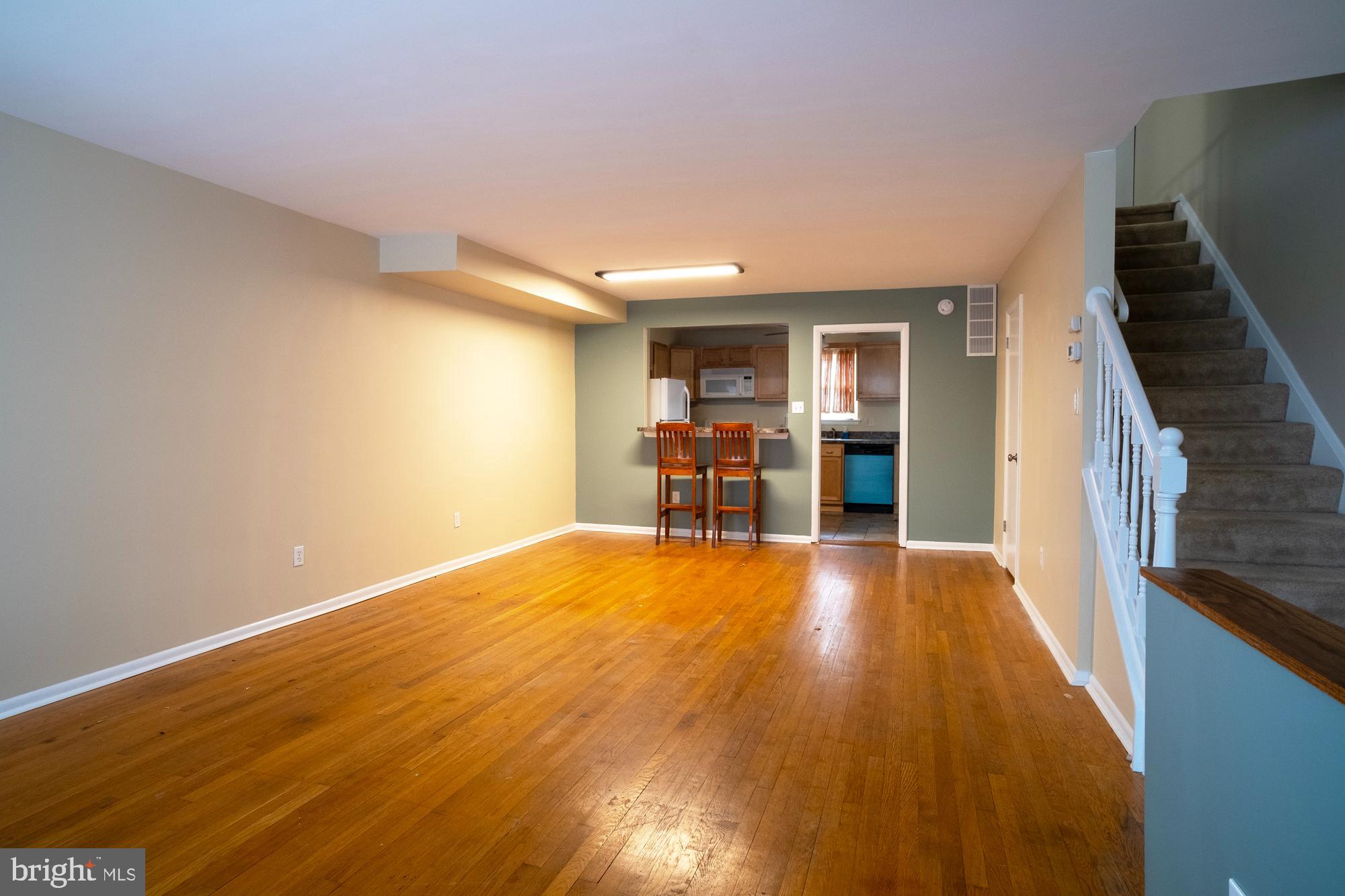 933 Elm Road Halethorpe, MD 21227 - Photo 2 of 11 a view of empty room with wooden floor and furniture