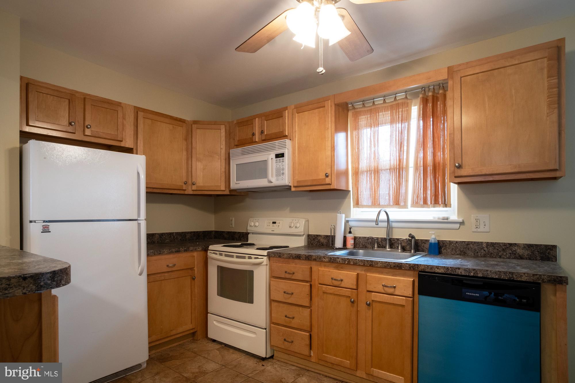 933 Elm Road Halethorpe, MD 21227 - Photo 3 of 11 a kitchen with white cabinets and white appliances