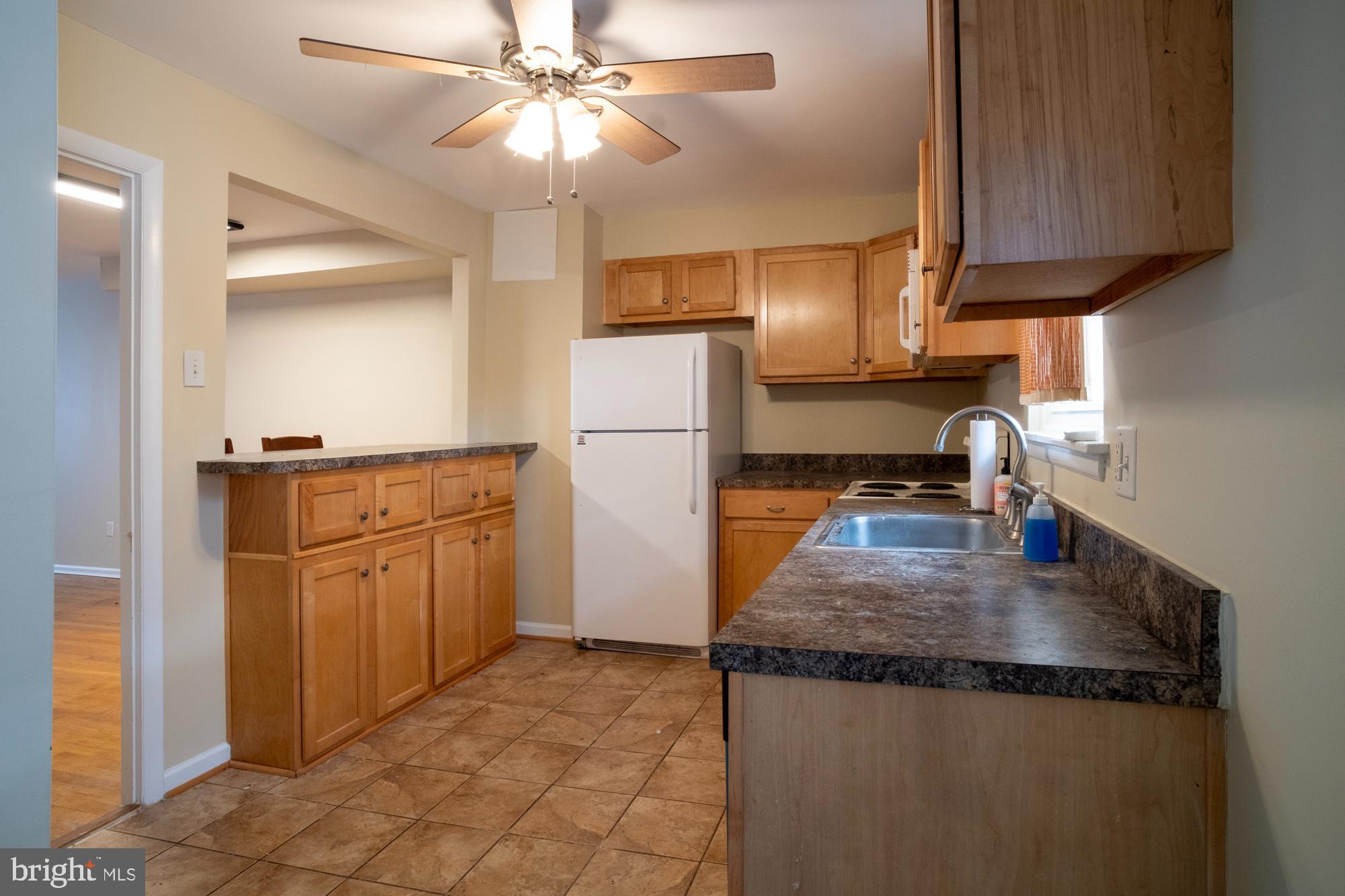 933 Elm Road Halethorpe, MD 21227 - Photo 4 of 11 a kitchen with refrigerator and cabinets