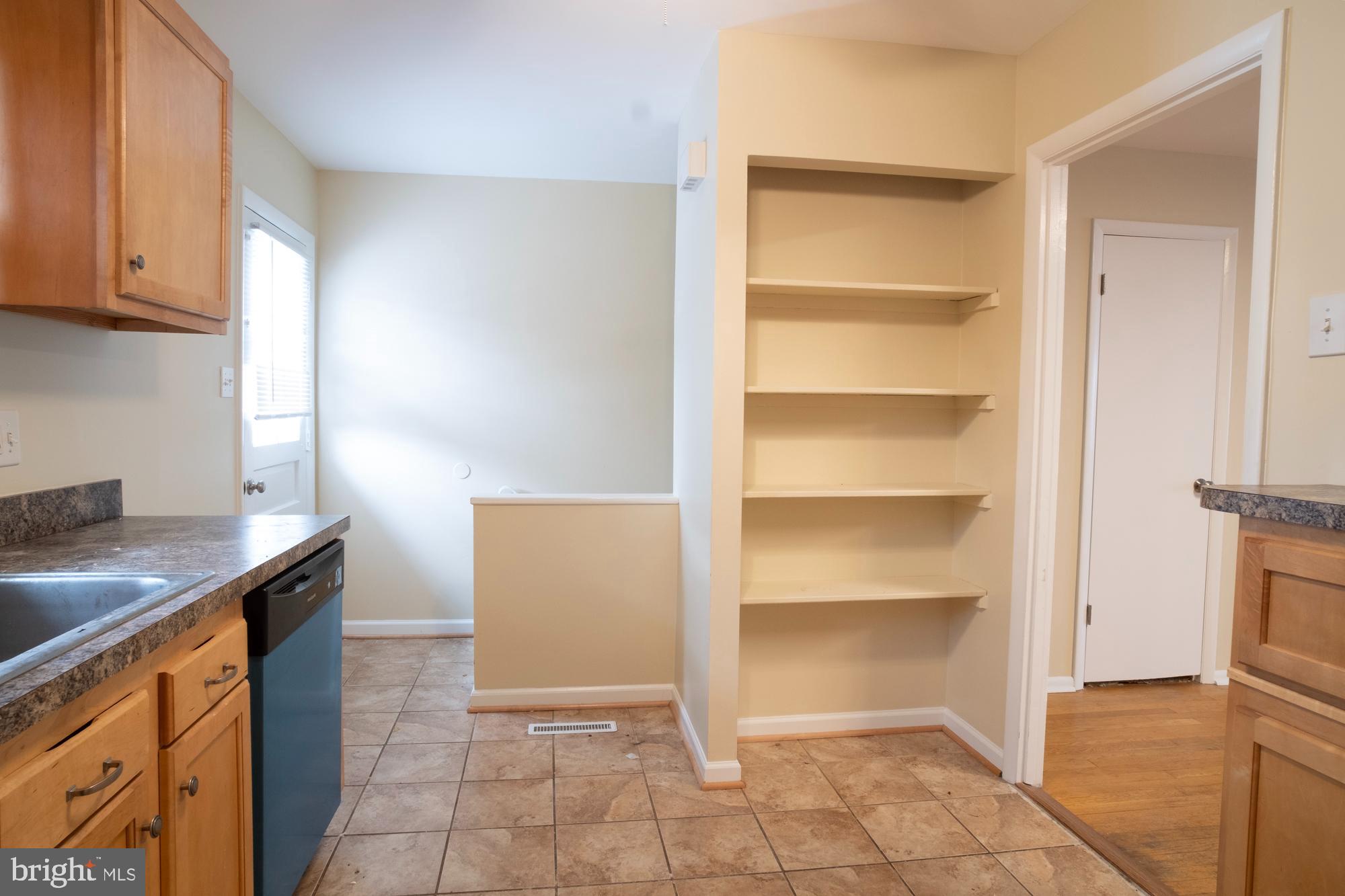 933 Elm Road Halethorpe, MD 21227 - Photo 5 of 11 a kitchen with white cabinets and a sink