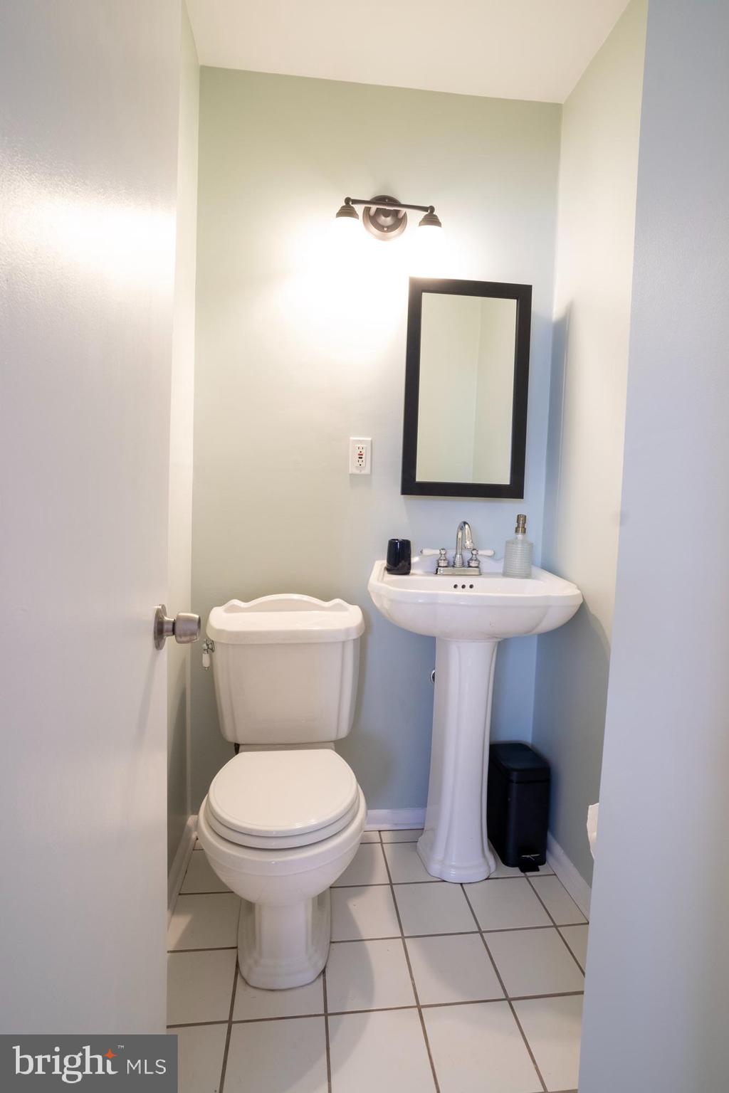933 Elm Road Halethorpe, MD 21227 - Photo 7 of 11 a bathroom with a toilet sink and mirror
