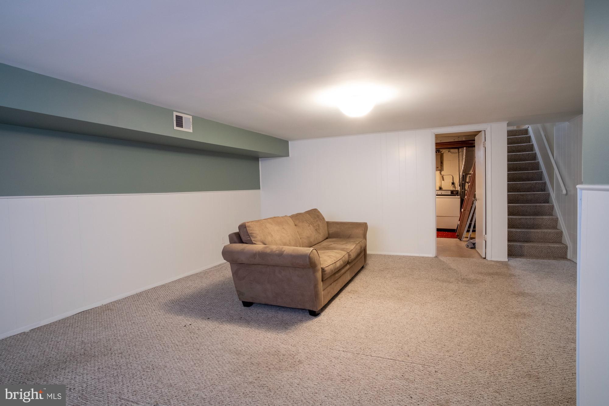 933 Elm Road Halethorpe, MD 21227 - Photo 9 of 11 a living room with furniture and stairs