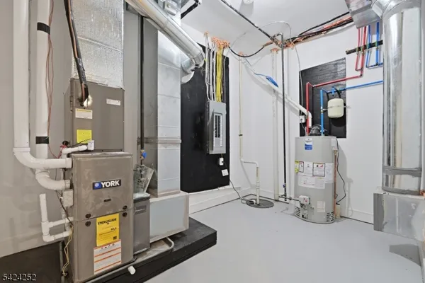 a view of a kitchen with stainless steel appliances granite countertop a sink a stove a refrigerator and island with wooden floor