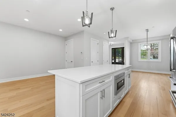 a kitchen with a stove and a wooden floor