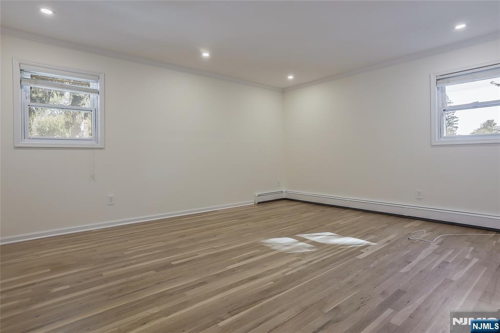 18 Ruth Lane Demarest, NJ 07627 - Photo 12 of 35 an empty room with wooden floor and windows
