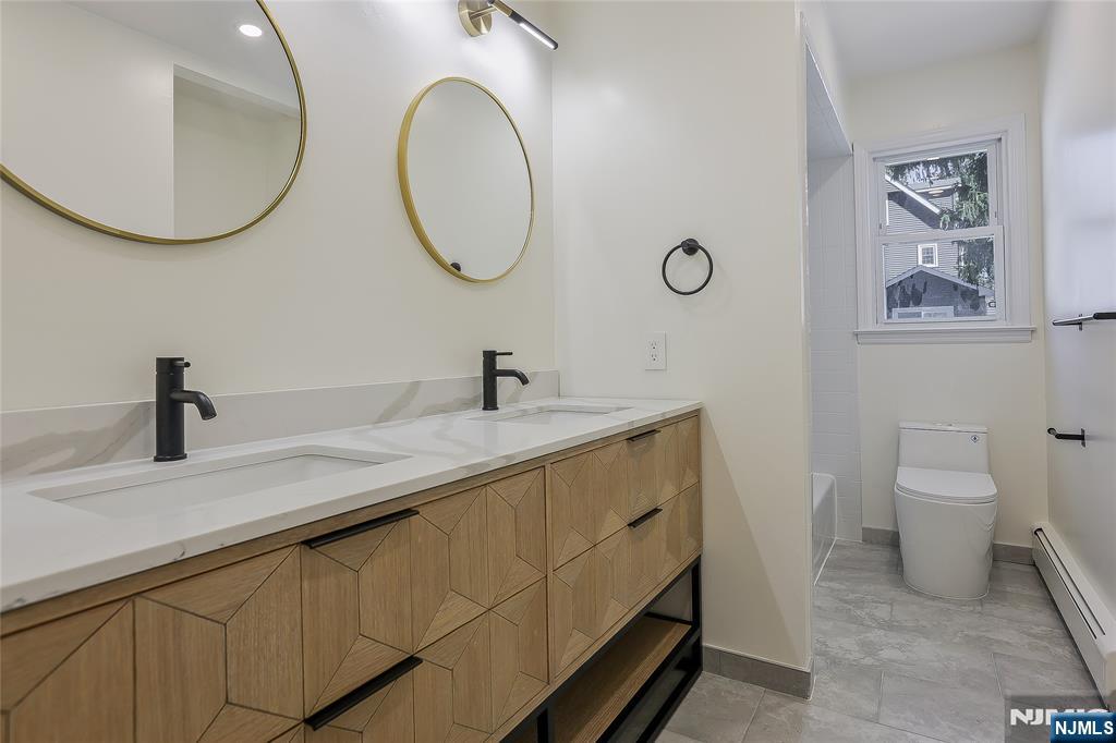 18 Ruth Lane Demarest, NJ 07627 - Photo 13 of 35 a bathroom with a toilet a sink and a mirror