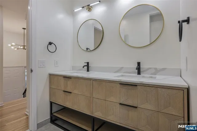 a bathroom with a double vanity sink and a mirror