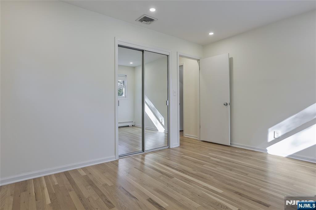 18 Ruth Lane Demarest, NJ 07627 - Photo 17 of 35 a view of an empty room with wooden floor and closet