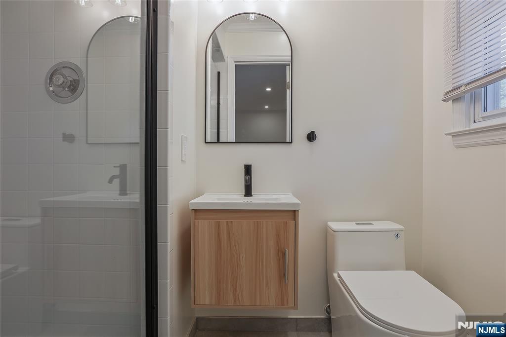 18 Ruth Lane Demarest, NJ 07627 - Photo 20 of 35 a bathroom with a toilet a sink a vanity and mirror