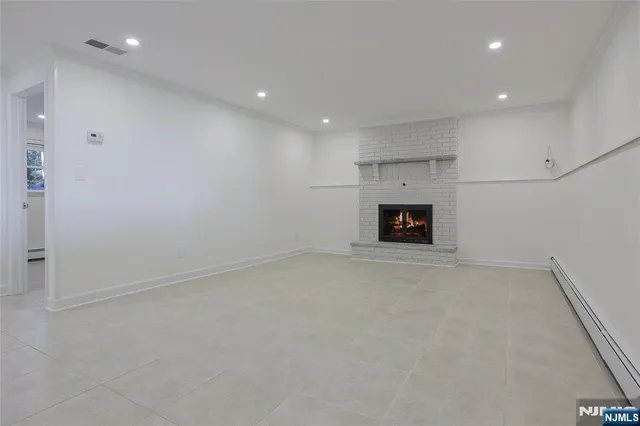an empty room with a fireplace and a window