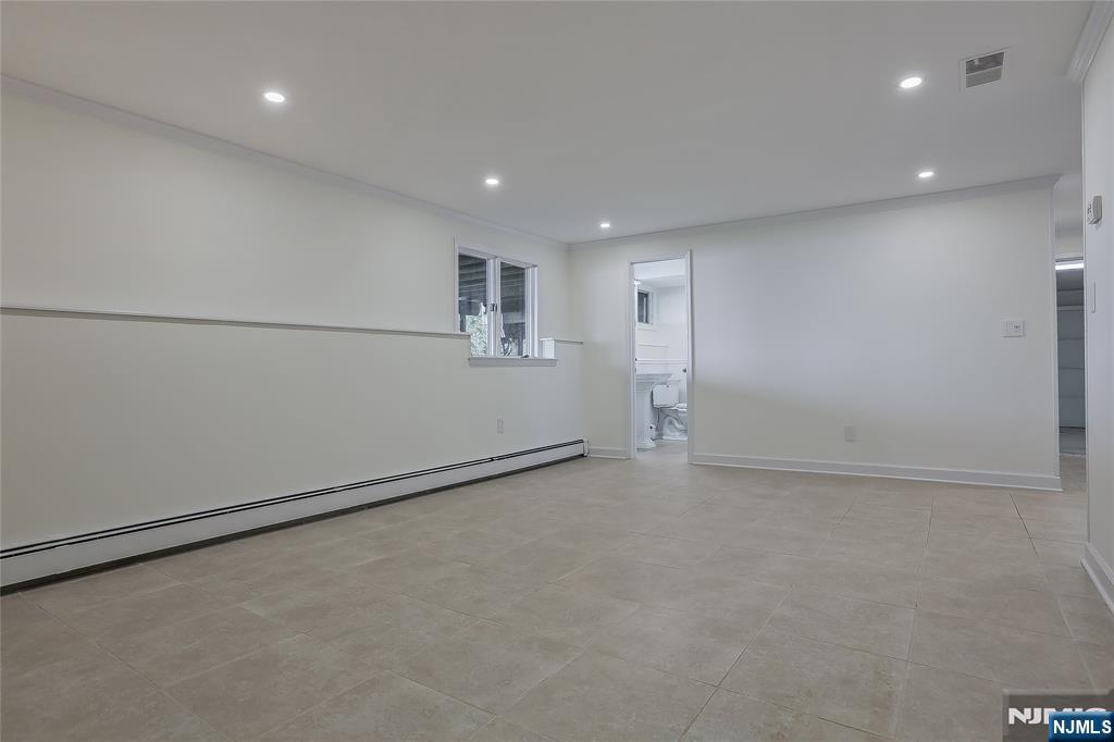 18 Ruth Lane Demarest, NJ 07627 - Photo 24 of 35 an empty room with cabinet and a refrigerator