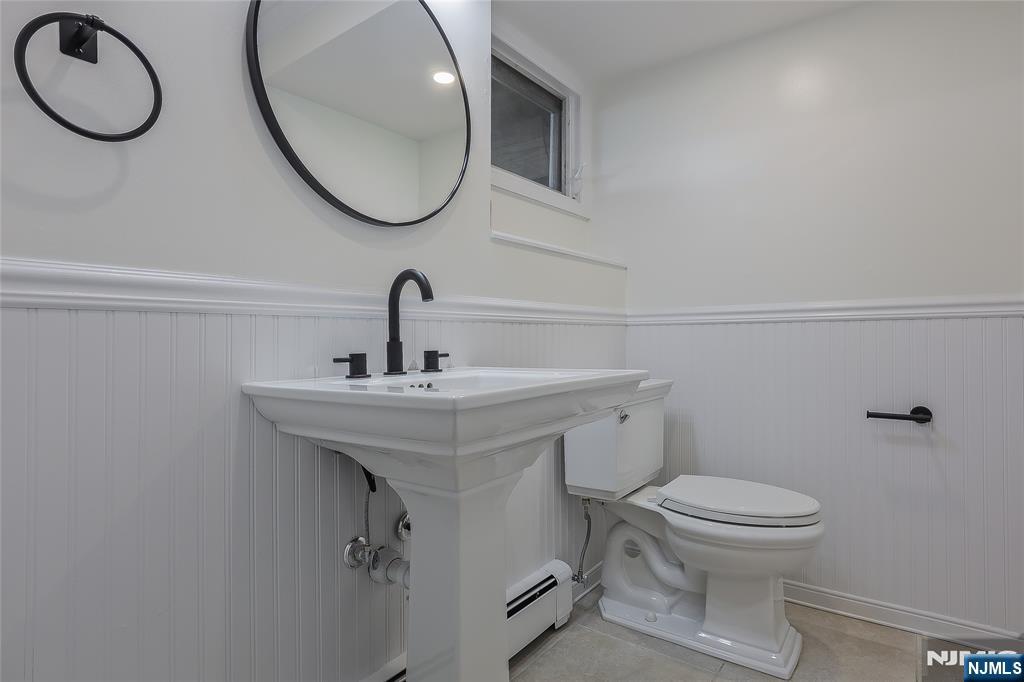 18 Ruth Lane Demarest, NJ 07627 - Photo 26 of 35 a bathroom with a toilet a sink and a mirror