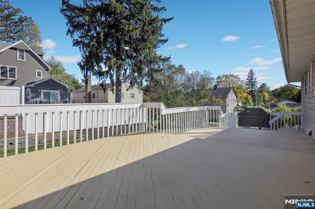 18 Ruth Lane Demarest, NJ 07627 - Photo 28 of 35 a balcony of a house with wooden floor fence and trees