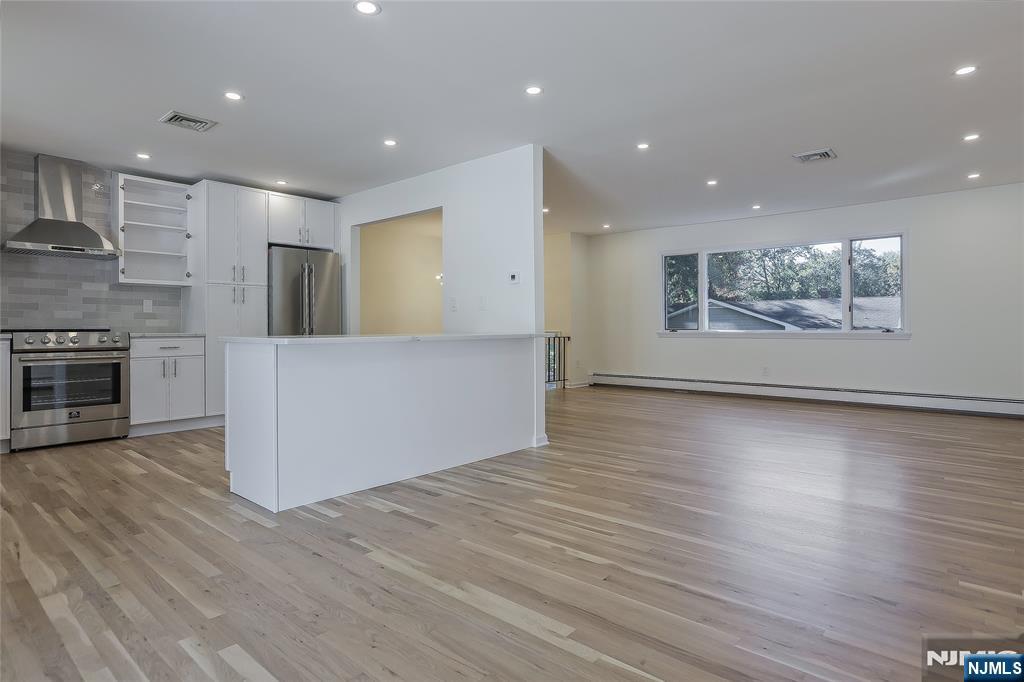 18 Ruth Lane Demarest, NJ 07627 - Photo 7 of 35 an empty room with wooden floor and natural light