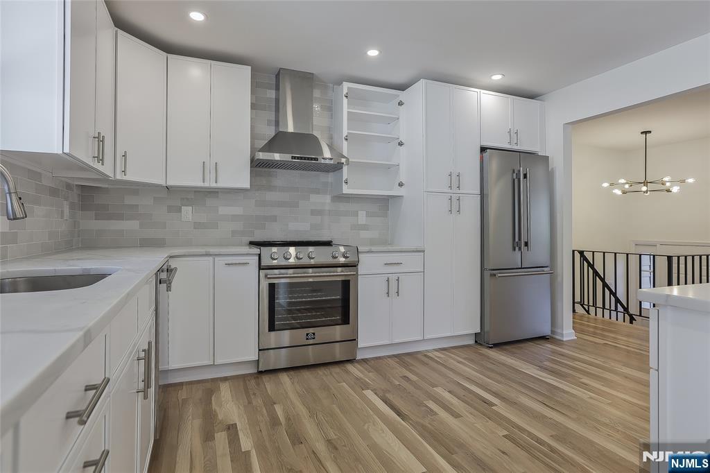 18 Ruth Lane Demarest, NJ 07627 - Photo 9 of 35 a kitchen with stainless steel appliances granite countertop a refrigerator a sink and a stove